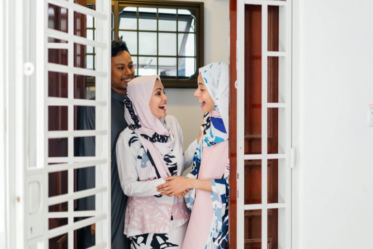 two women standing by the door