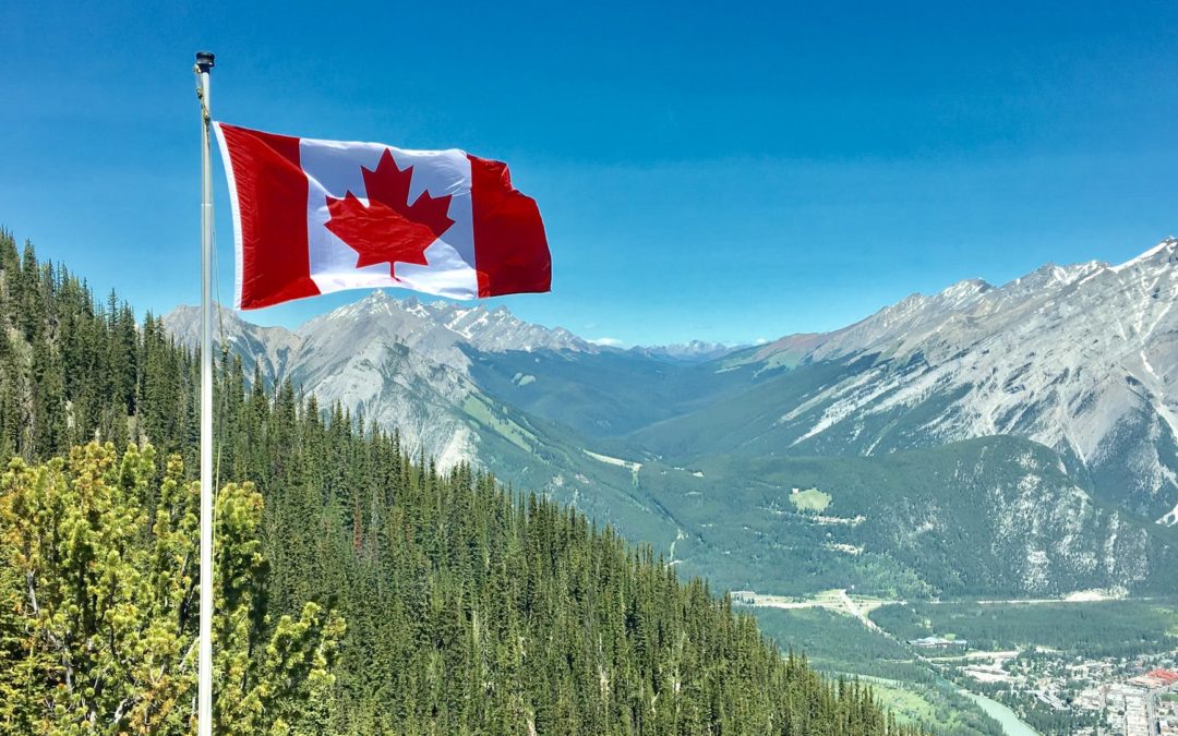 canada flag with mountain range view